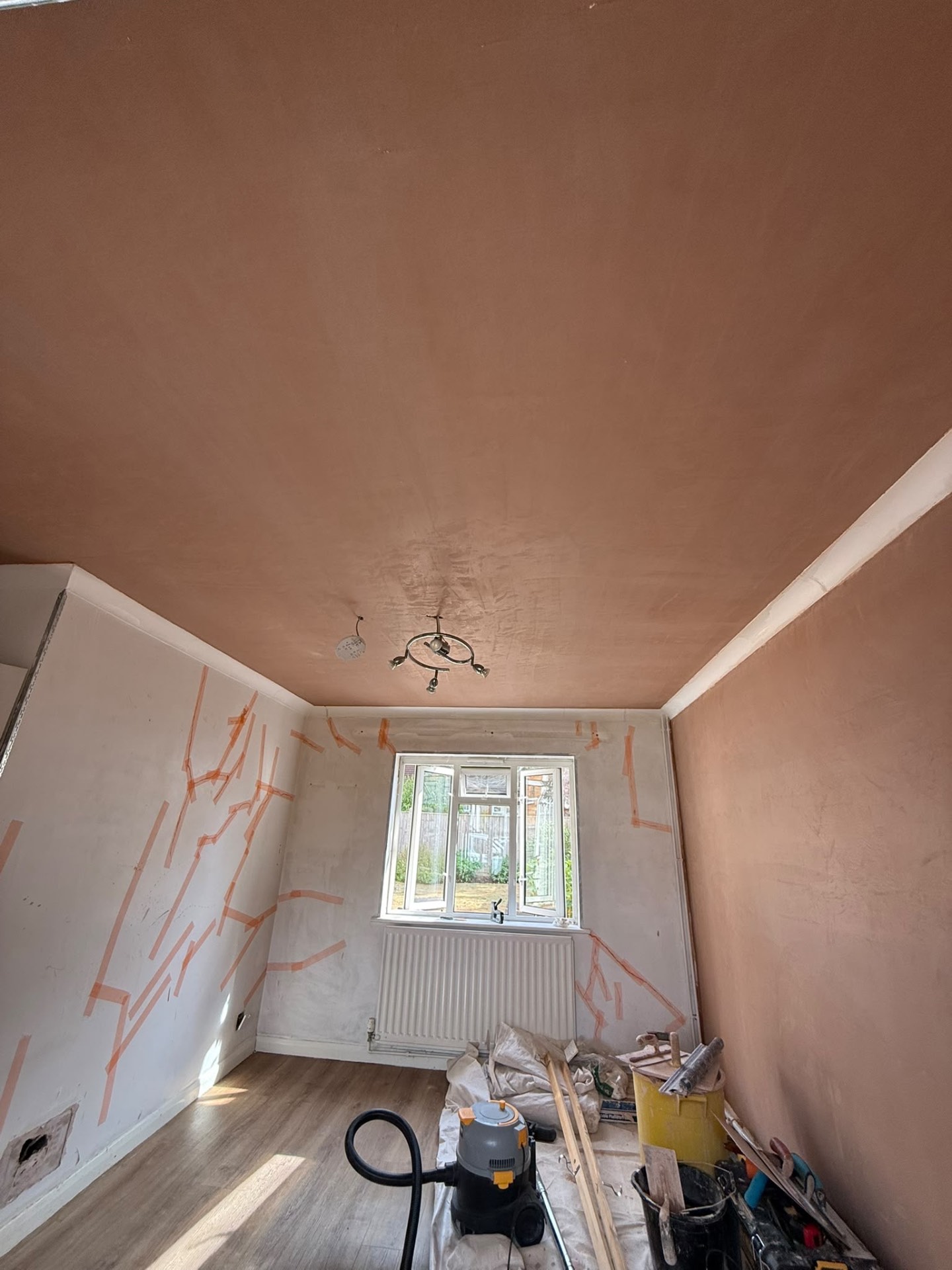 Newly plastered ceiling and wall during a room refurbishment